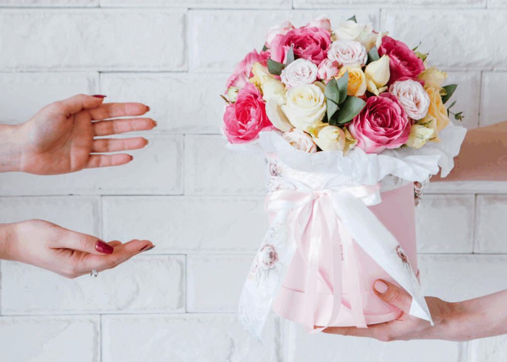 A Image of a flower set being handled to another person
