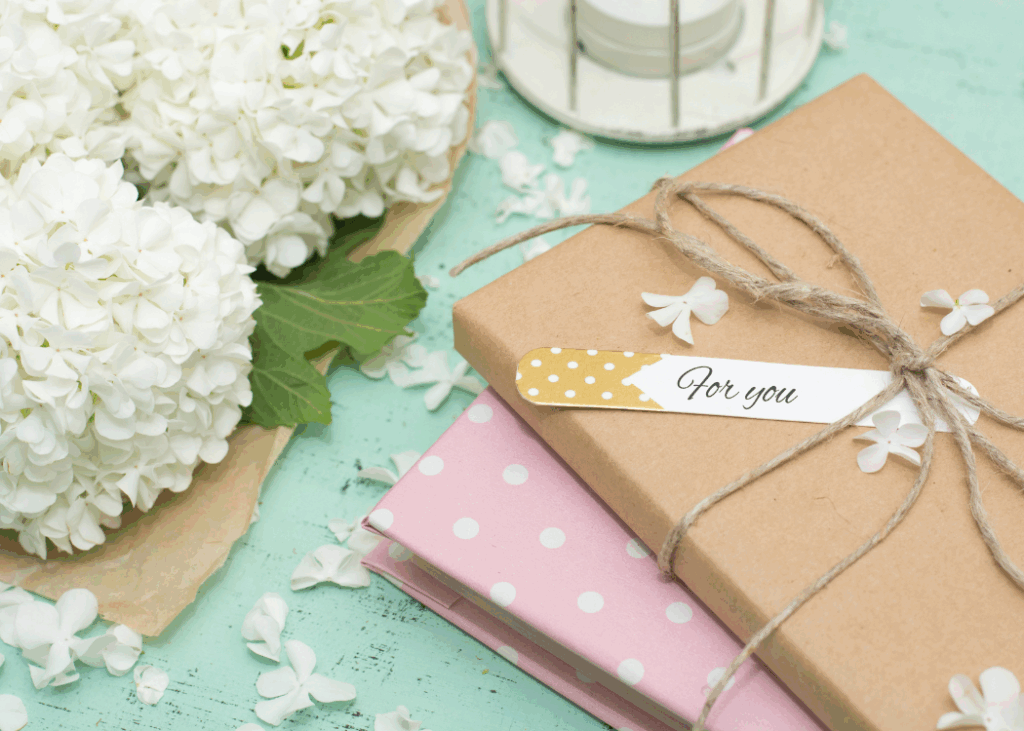A closeup Image of a gift Box with a Flower on the top left