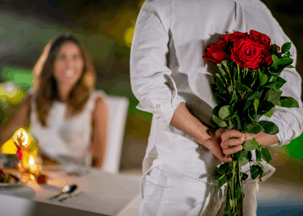A Backshot Image of a guy Holding a Flower Behind his back surprising a women