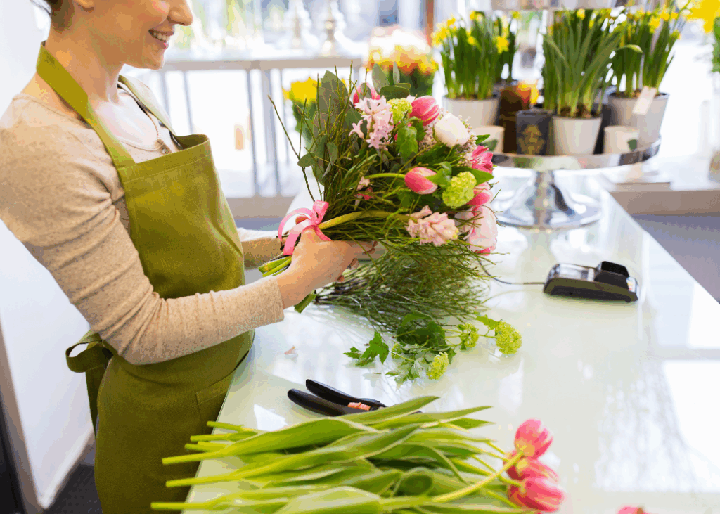 A Image of a woman Arranging a set of flowers